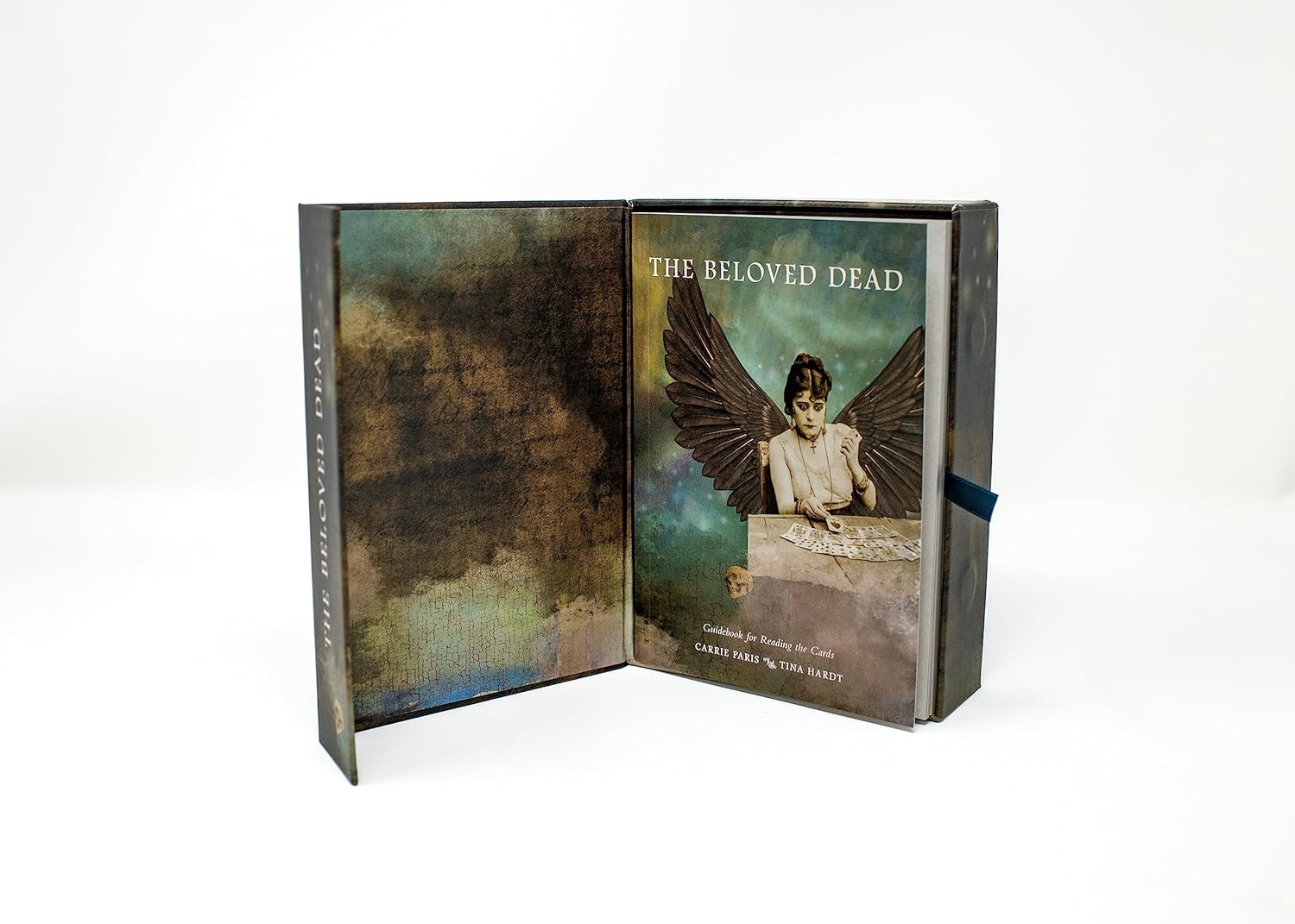Book titled 'The Beloved Dead' with a cover featuring an angelic figure on a white background