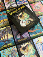 Collection of colorful tarot cards with dragon illustrations and 'Ravyness Drakon Tarot' box.