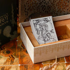 Card in a box with decorative background featuring tarot cards and occult symbols