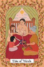 Illustrated tarot card design titled 'Elder of Wands' showing a seated figure holding a baby in a crib while two others prepare offerings, with a peach-toned floral border and green canopy.