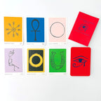 Set of tarot cards with various symbols and colors on a white background