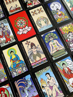 Collection of colorful tarot cards with various designs and figures.