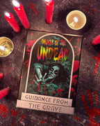 Card titled 'Oracle of the Undead' with candles on a dark surface