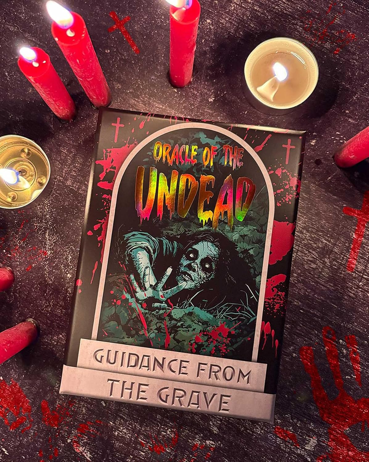 Card titled 'Oracle of the Undead' with candles on a dark surface