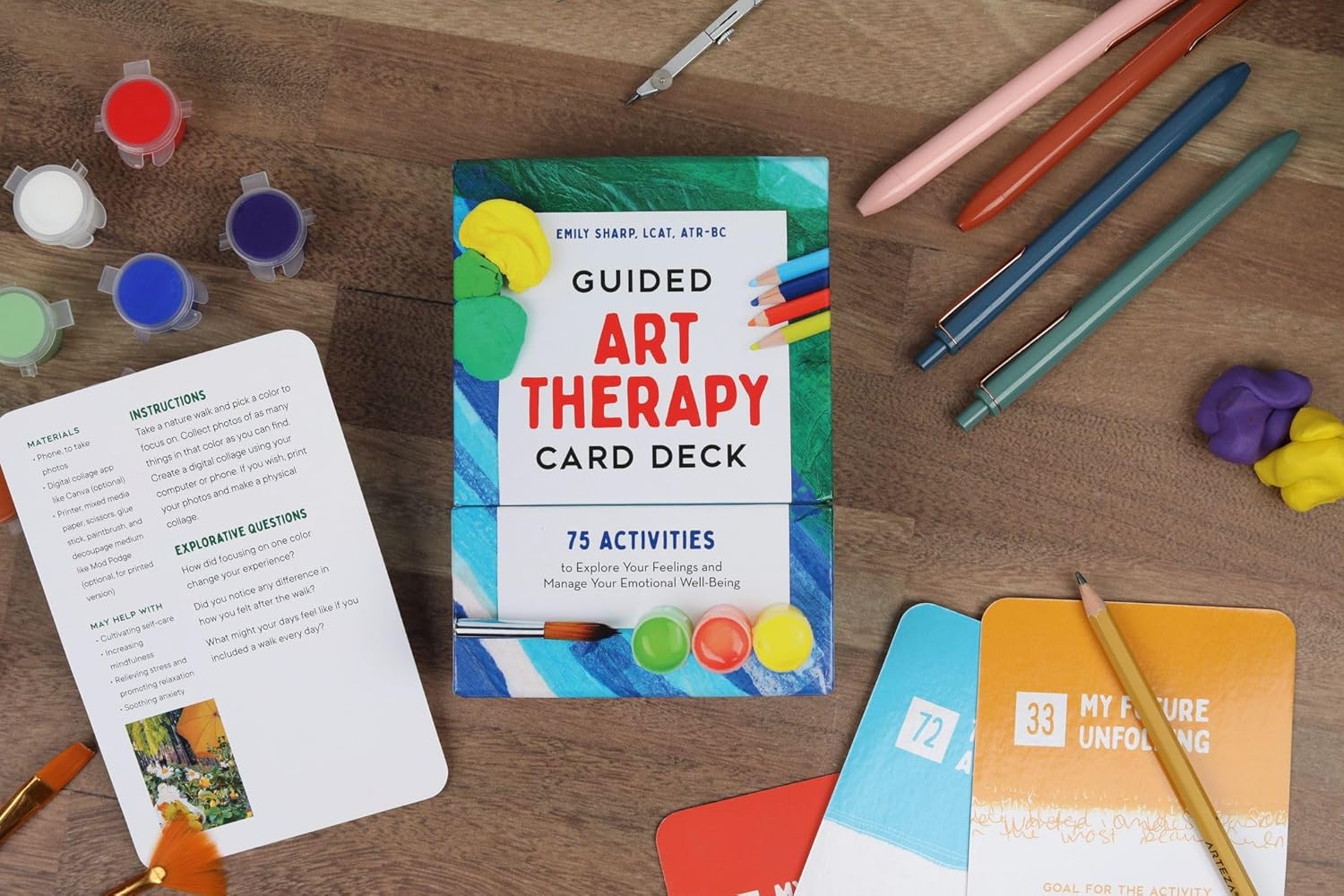 Guided Art Therapy Card Deck on a wooden surface with art supplies