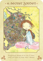 Anamchara '12. Secret Garden' oracle card featuring an illustration of a girl with red hair sitting on the ground next to a large, flower-covered creature on a yellow-green background.