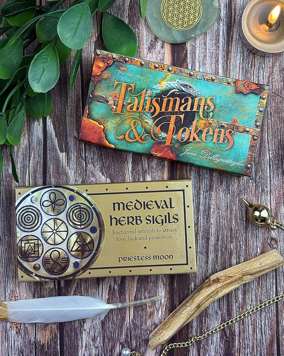 Two product boxes on a wooden surface with decorative elements.