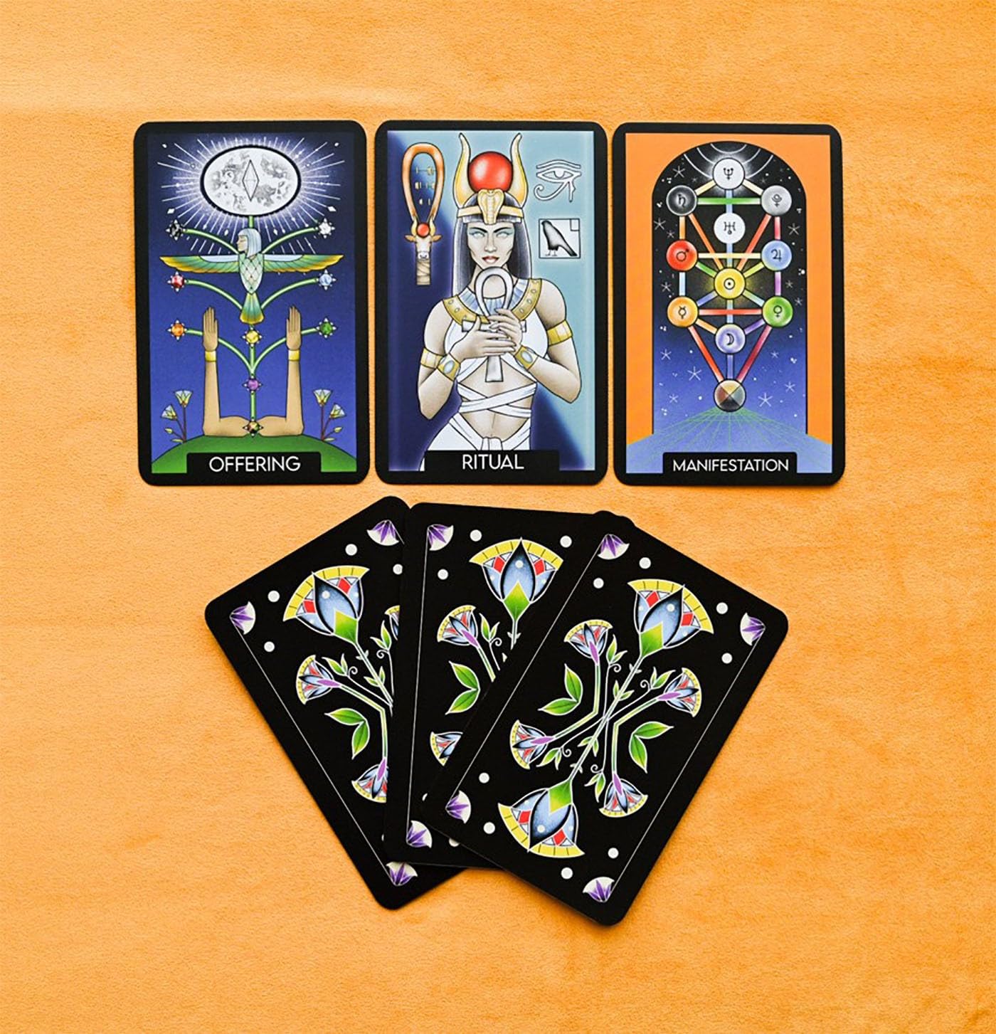Set of tarot cards with colorful designs on a wooden surface