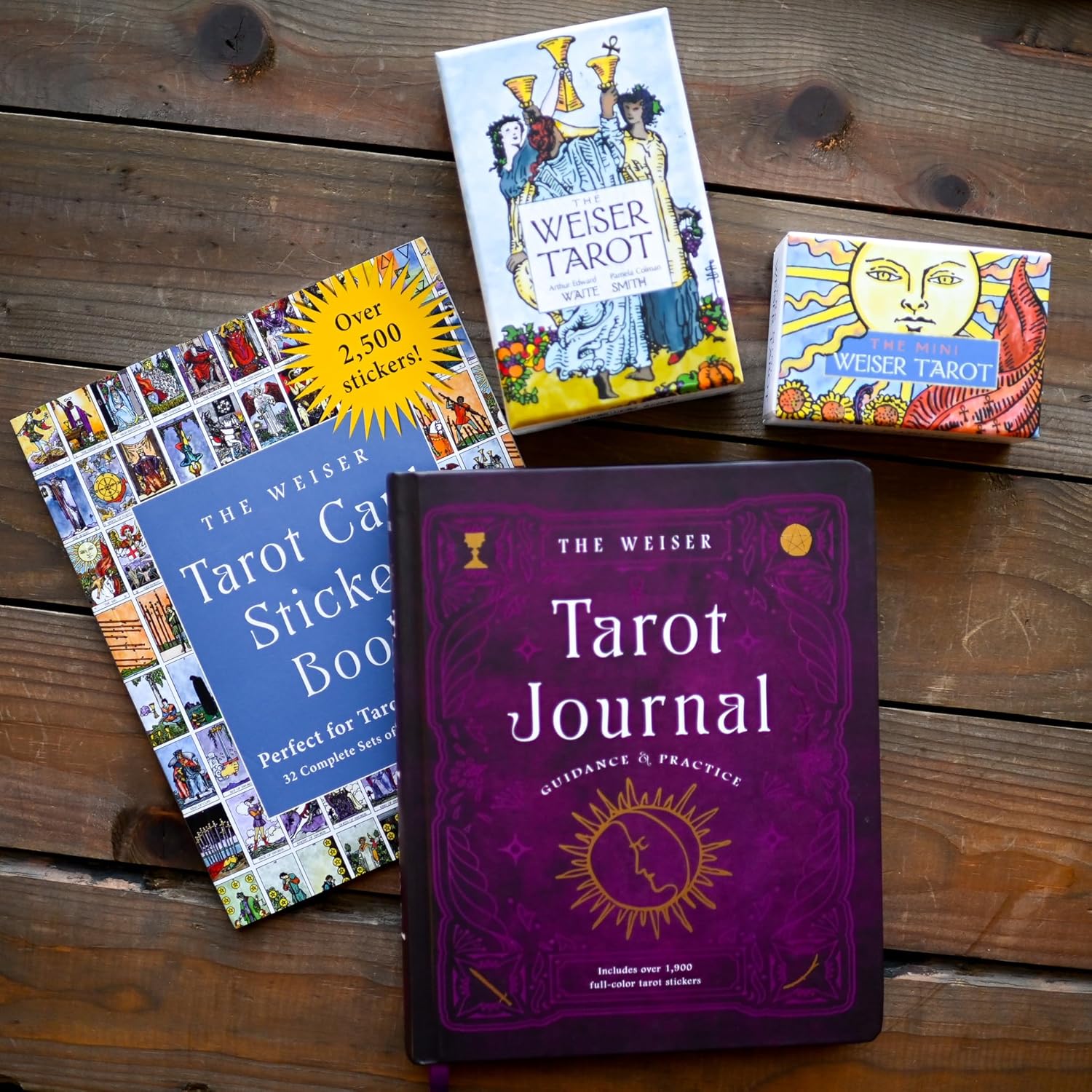 Collection of tarot books and a journal on a wooden surface