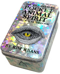 Holographic tin box with eye illustration and text 'The Wild Unknown Pocket Animal Spirit Deck & Guidebook by Kim Krans'.