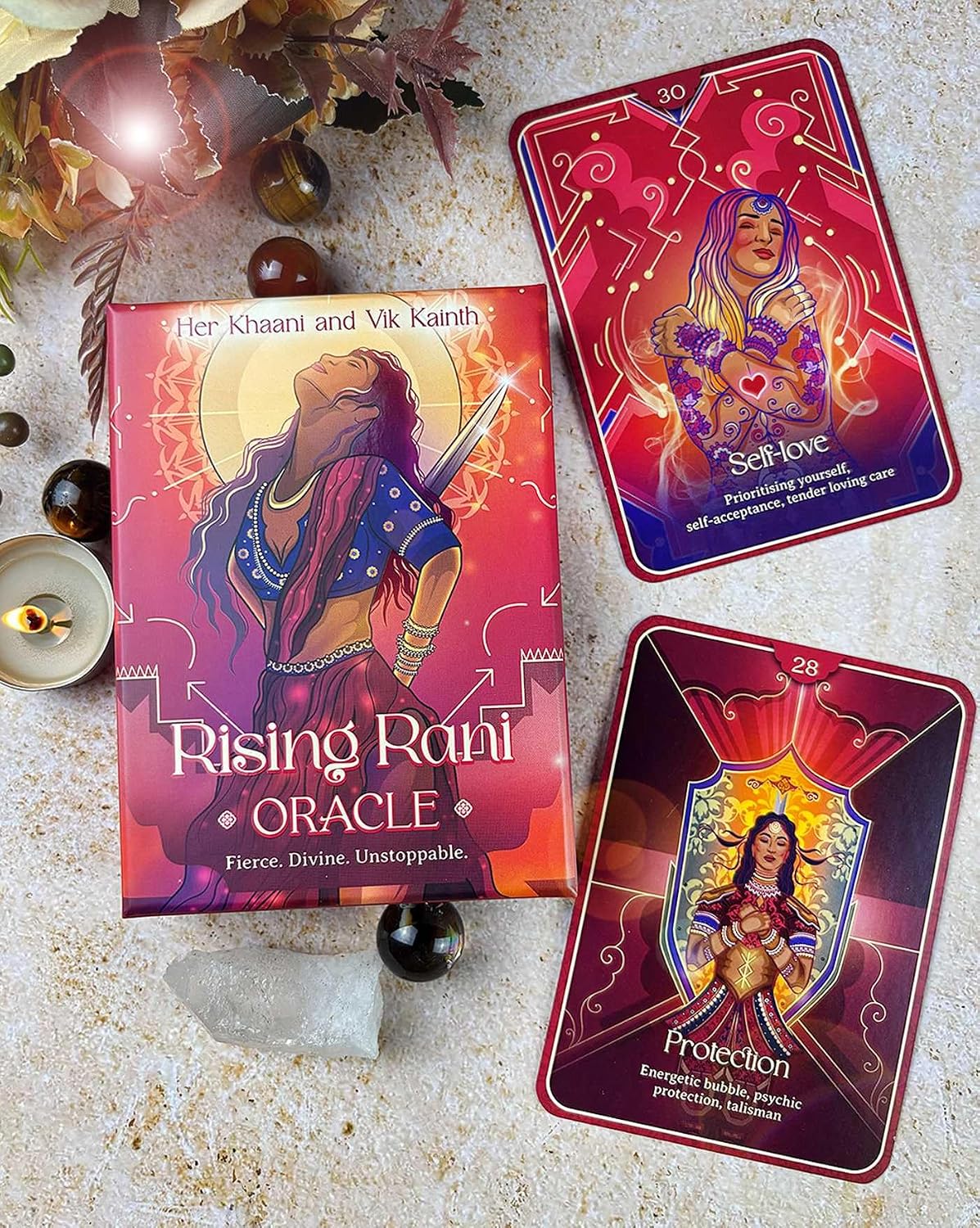 Rising Rani Oracle cards with packaging on a textured surface.