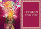 Rising Rani Oracle Cards deck box cover featuring a stylized illustration of a woman with a glowing planet and cosmic swirls on the left, and the title 'Rising Rani Oracle Cards' on a magenta panel with decorative border on the right.
