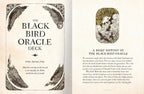 An open book or oracle card spread showing the front cover and interior text page for 'The Black Bird Oracle Deck.' The left page has ornate black bird illustrations and the title in large serif text, while the right page contains a short article titled 'A Brief History of the Black Bird Oracle.