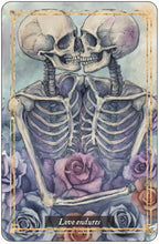 Two kissing skeletons surrounded by roses with the text 'Love endures' on a decorative border.