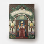 Cottage Magic Tarot box with illustration of a woman in a garden setting on a white background