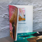 Open book with illustrations of dogs and text on a textured surface