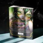 A hardcover art book titled 'The Art of Anger' by D'Angelo, standing upright on a light blue surface against a dark, marbled background. The cover features a highly detailed, colorful illustration of a woman with green hair and glowing eyes holding a dragon.