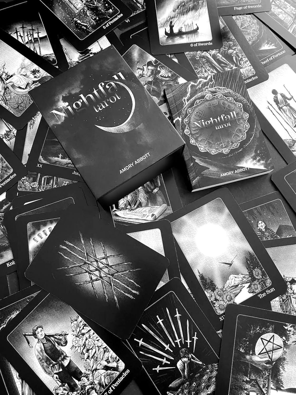 Collection of 'Nightfall Tarot' cards with a box on top, featuring black and white artwork.
