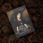 Light In the Darkness Oracle Companion Book on a bed of pine cones