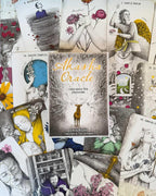 Collection of tarot cards with 'Akhava Oracle' book in the center