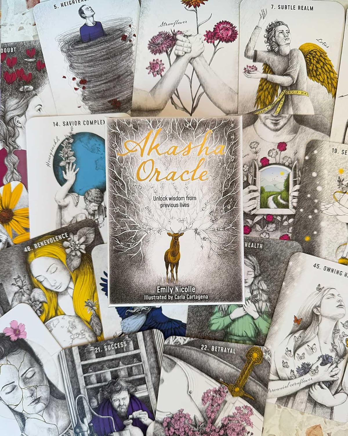 Collection of tarot cards with 'Akhava Oracle' book in the center