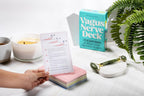 Vagus Nerve Deck with cards and a roller on a table with a candle and plant.