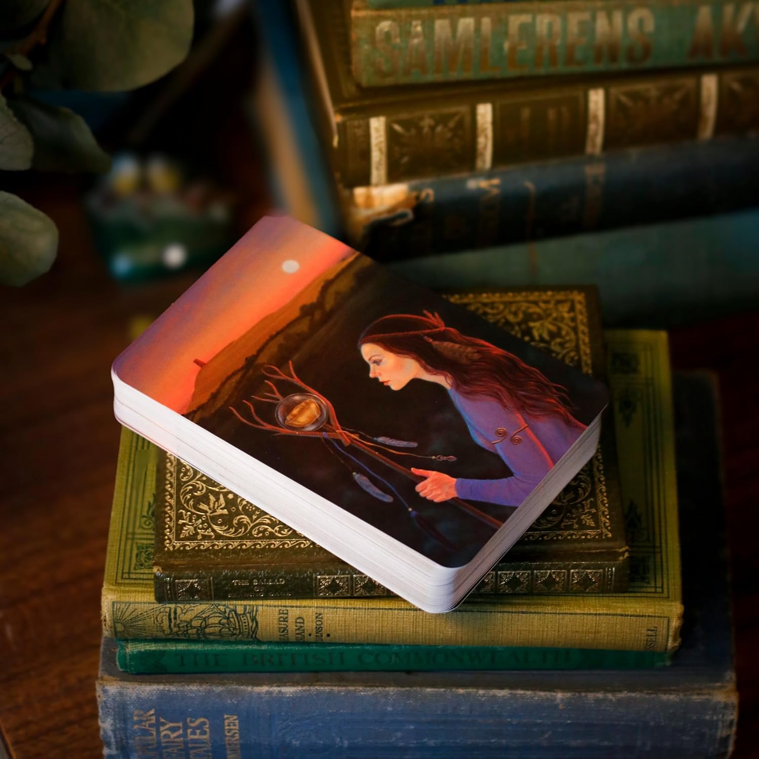 Card with a woman holding a bouquet on top of vintage books