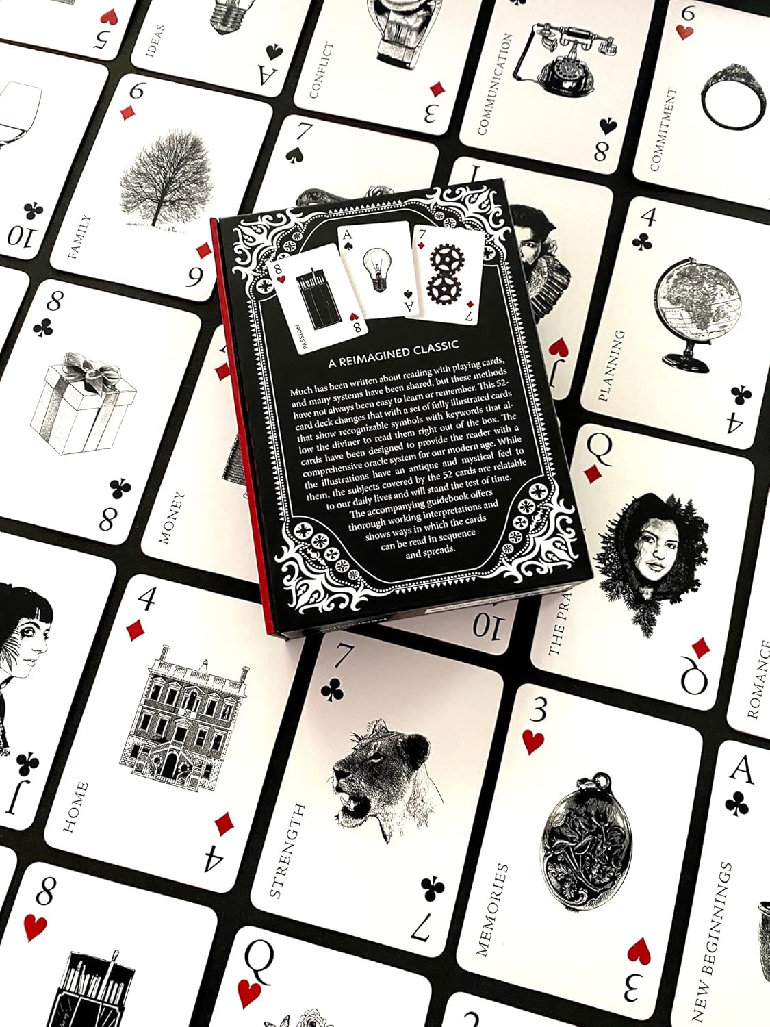 Book on a deck of playing cards with black and white illustrations