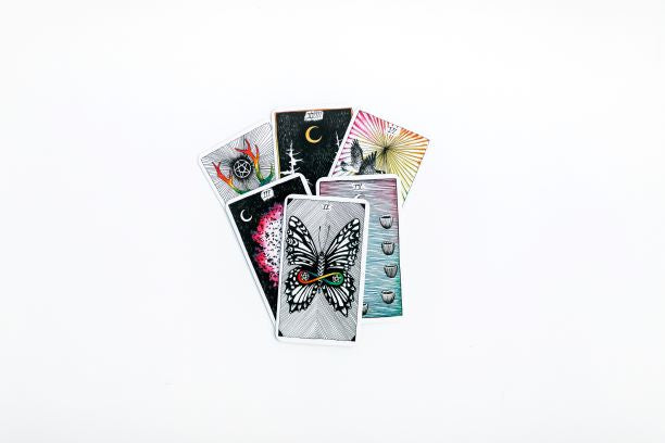 Collection of tarot cards with various designs on a white background