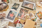 Collection of tarot cards and a notebook on a textured surface with decorative elements.