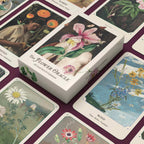 Flower Oracle card deck with cards spread out on a matching purple background