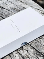 White card with 'DEATH DOULA' text on a wooden surface