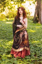 Woman in a fantasy dress standing in a forest