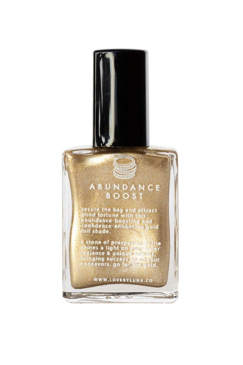 Gold bottle labeled 'Abundance Boost' on a white background