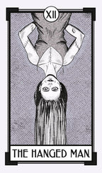 Tarot card 'The Hanged Man' with a black and white illustration of a person hanging upside down.