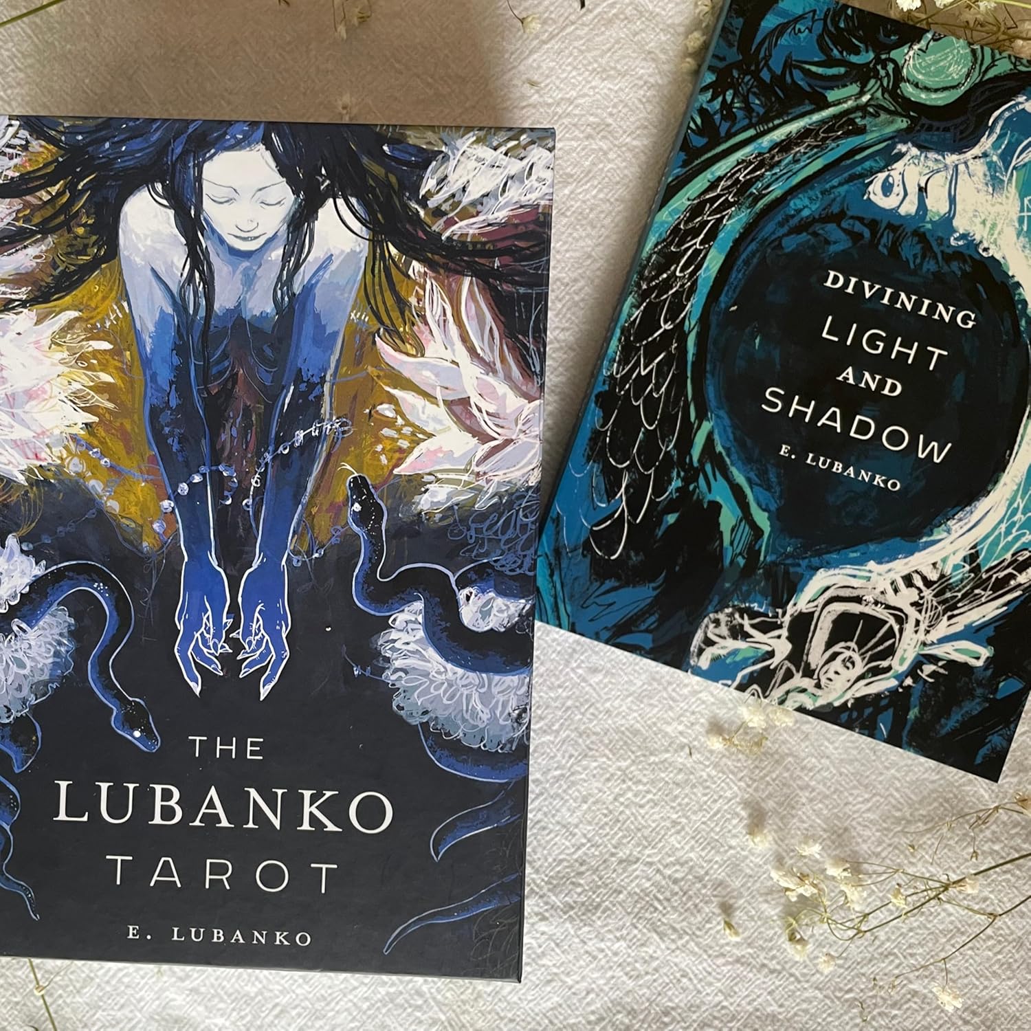 Two tarot card books by E. Lubanko on a textured surface