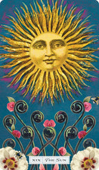 Tarot card featuring a sun with facial features, flowers, and blackberry-like plants on a blue background.