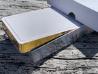 Metallic object with gold and silver finish on a wooden surface