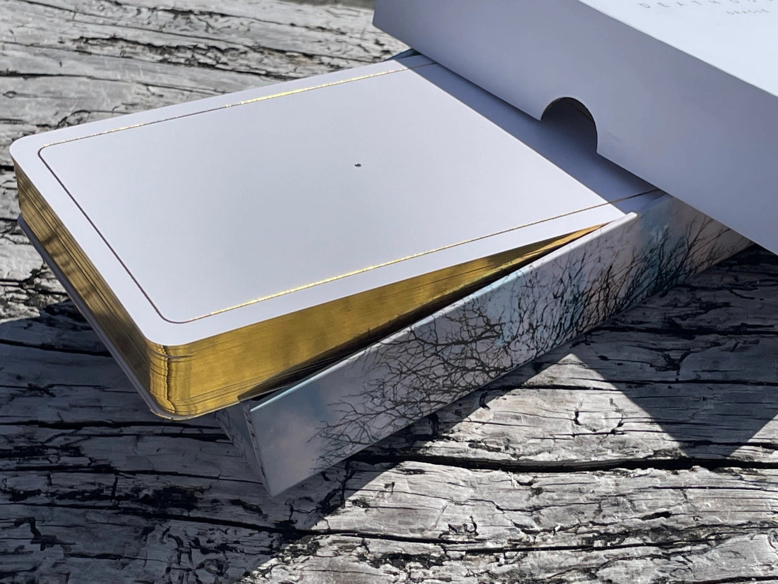 Metallic object with gold and silver finish on a wooden surface