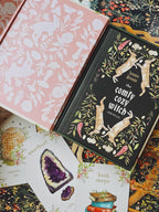 Decorative books with floral and nature-themed covers on a colorful background