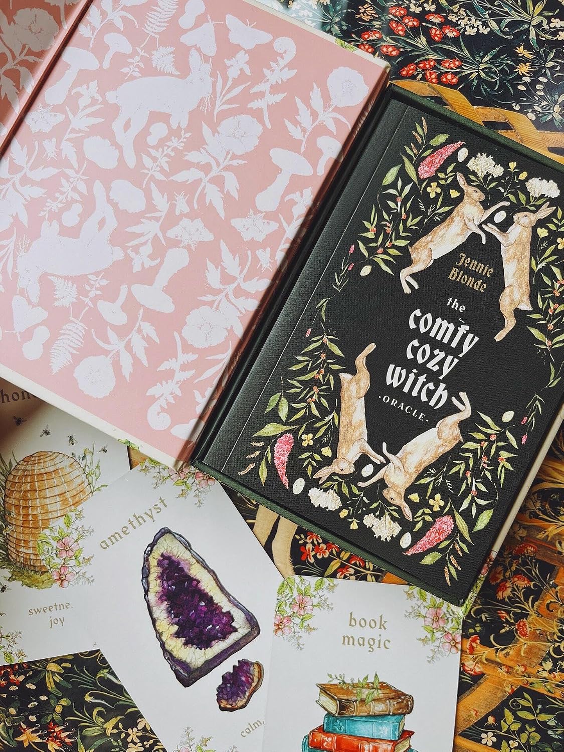 Decorative books with floral and nature-themed covers on a colorful background