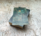 Stack of tarot cards with 'The Magician' card on top, on a textured surface