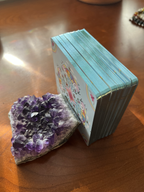 Amethyst crystal and a small box on a wooden surface