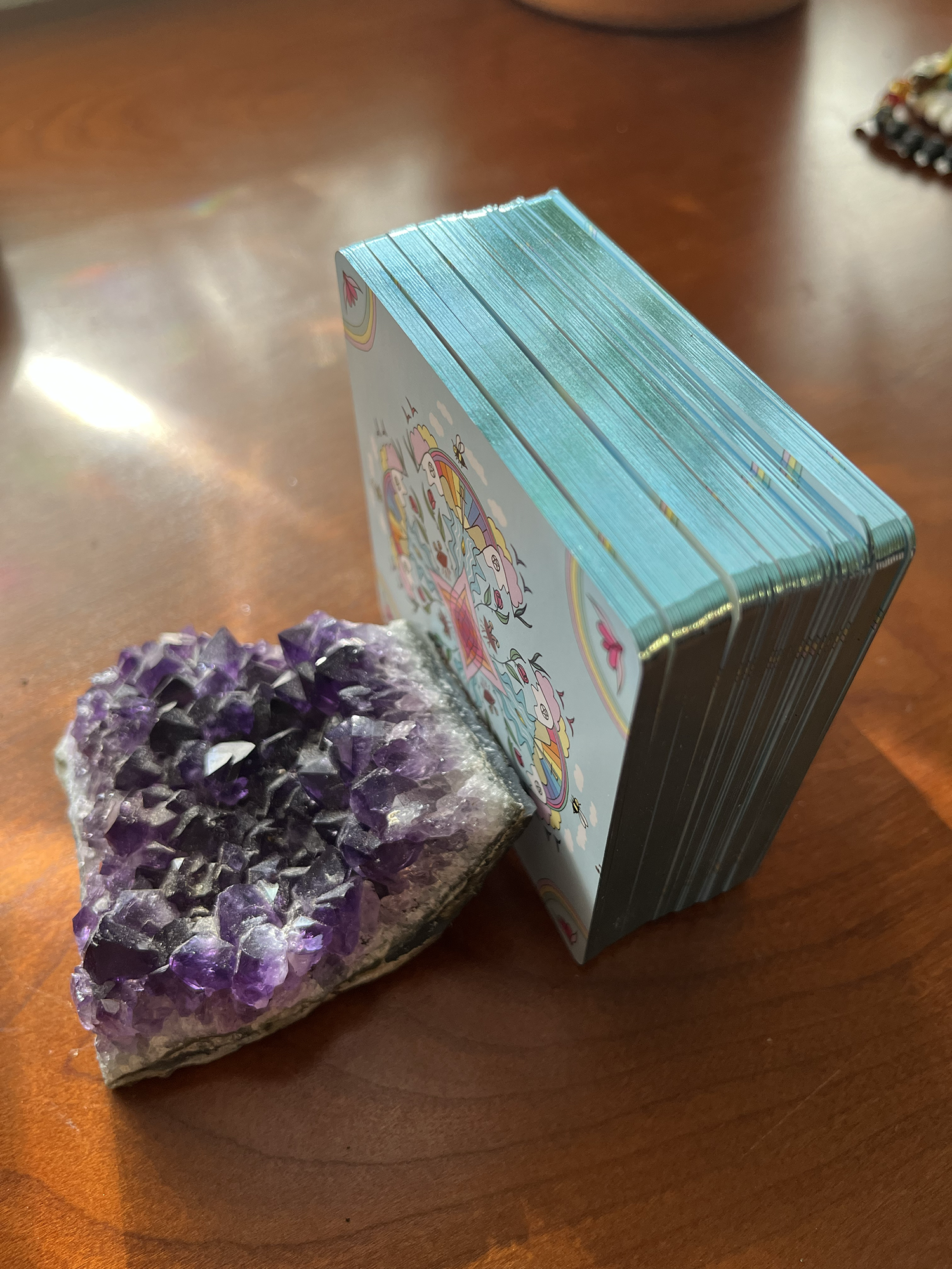 Amethyst crystal and a small box on a wooden surface