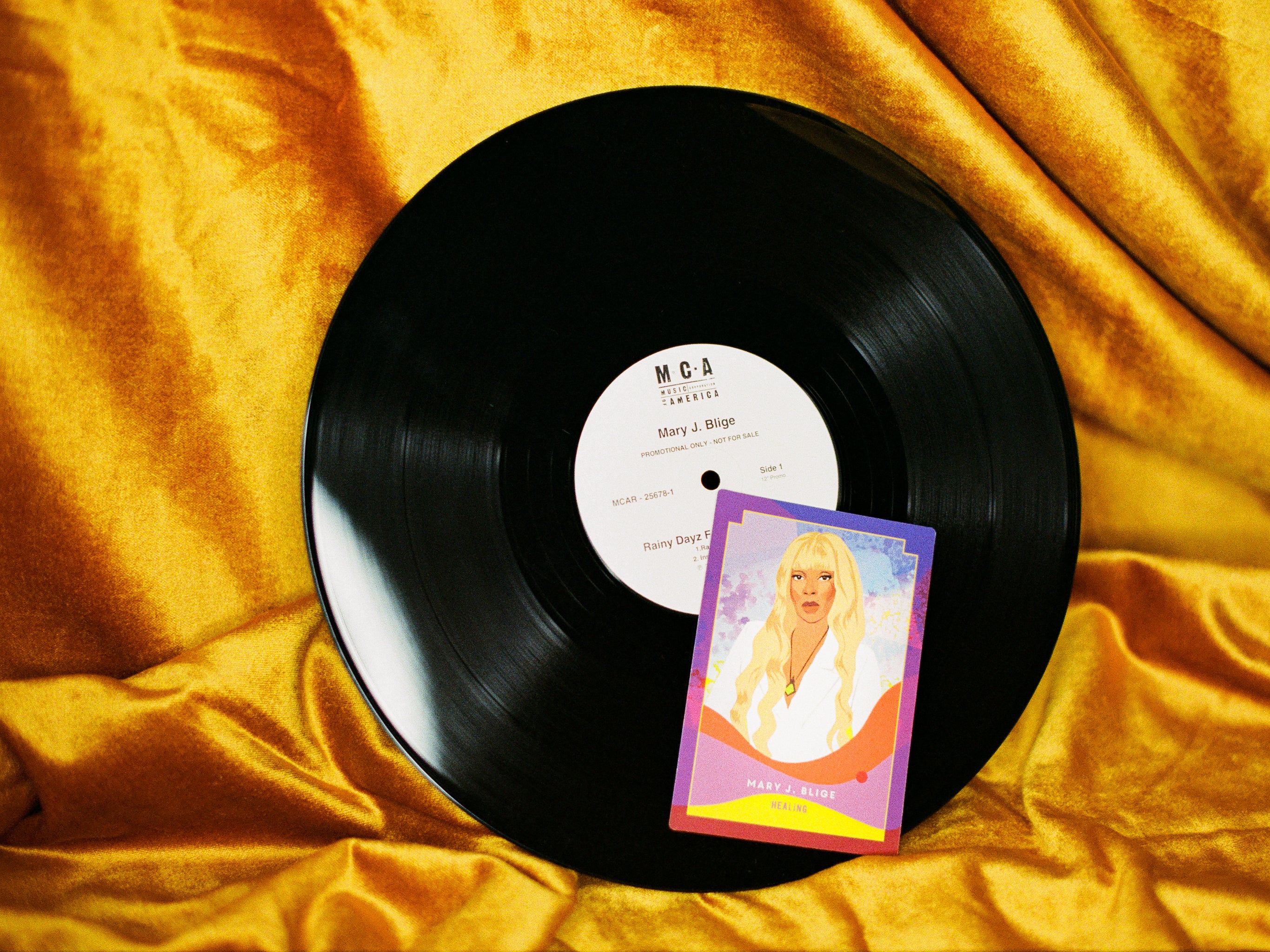 Vinyl record with a picture of a woman on a yellow fabric background