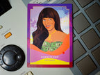 Card featuring a stylized illustration of a woman with text 'Gangsta Boo' on a keyboard and electronic device background.