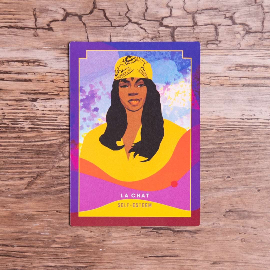 Colorful card with a stylized illustration of a woman wearing a yellow headscarf on a wooden surface.