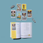 Open book with tarot cards displayed on a blue background