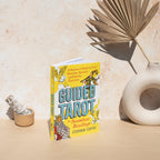 Book titled 'Guided Tarot' on a beige surface with decorative elements.