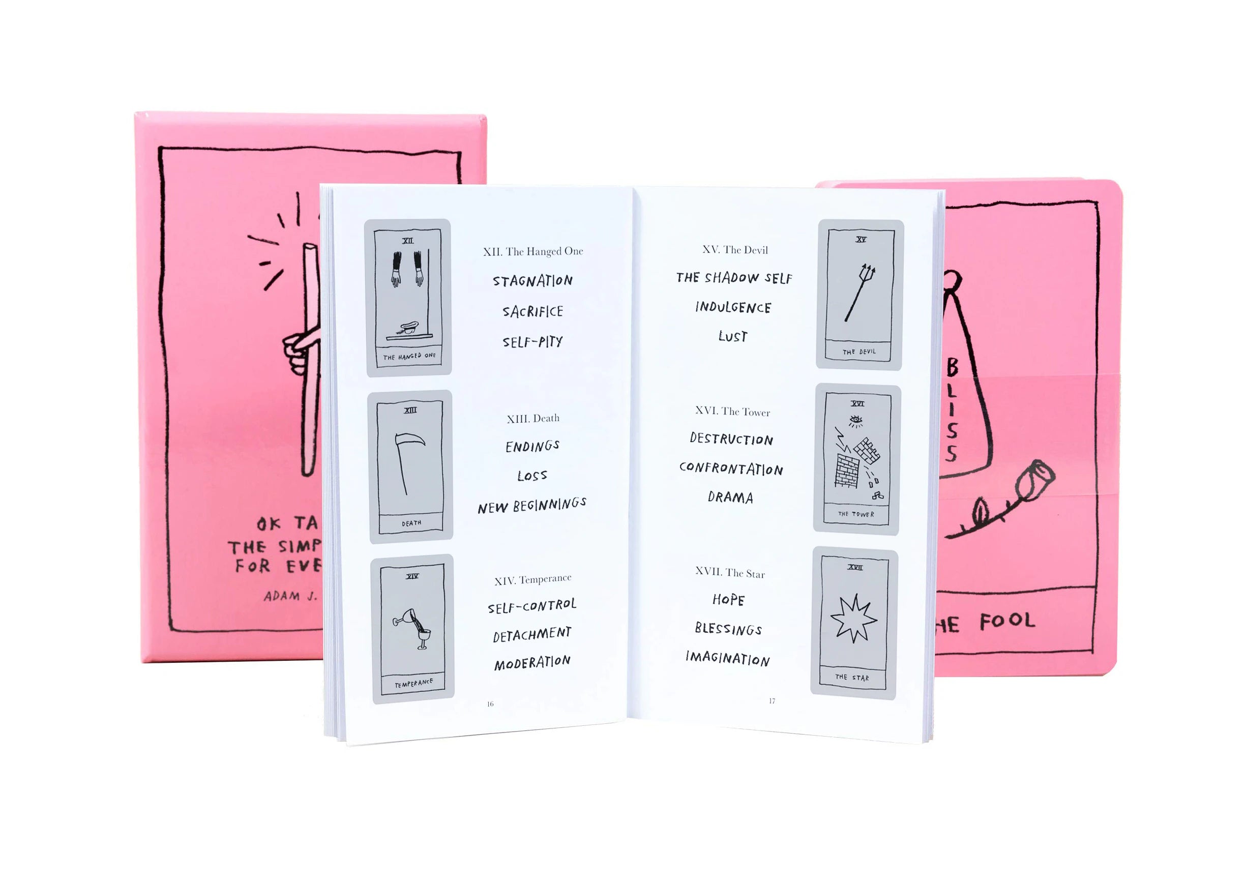 Open book with tarot card illustrations and text on pink covers